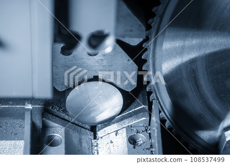 Close up scene the operation of circular blade saw cutting machine cutting the metal shaft parts with coolant method. 108537499