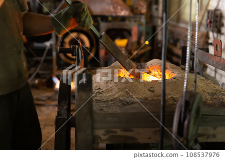Ferrous metal billet is melted in an induction furnace closeup 108537976