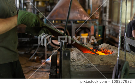 Ferrous metal billet is melted in an induction furnace closeup Ferrous metal billet is melted in an induction furnace closeup 108537982