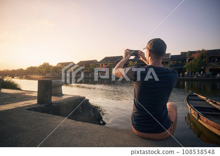 Man photographing Hoi An cityscape in Vietnam. Man photographing Hoi An cityscape in Vietnam. 108538548
