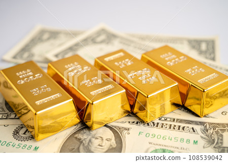 Gold bar on US dollar banknotes money and graph, economy finance exchange trade investment concept. 108539042