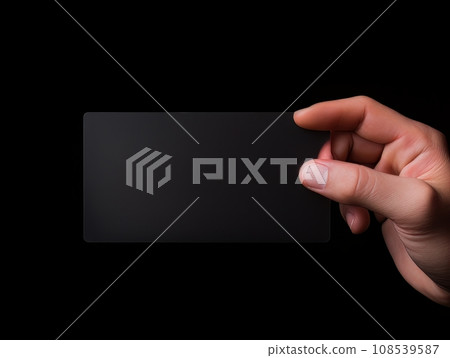 Male hand holding a black bank card on a black background AI 108539587