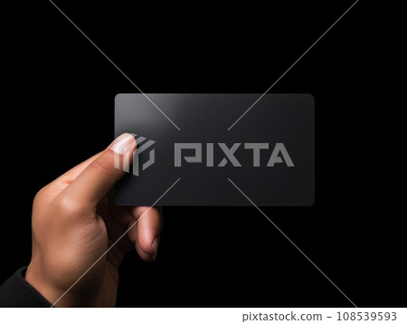 Male hand holding a black bank card on a black background AI 108539593