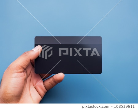 Male hand holding a black bank card on a blue background AI Male hand holding a black bank card on a blue background AI 108539611