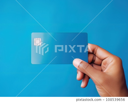 Male hand holding a blue bank card on a blue background AI 108539656