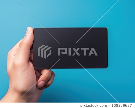 Male hand holding a black bank card on a blue background AI Male hand holding a black bank card on a blue background AI 108539657
