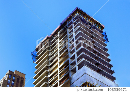 Large American city is in process of building new skyscrapers on its construction site Large American city is in process of building new skyscrapers on its construction site 108539671