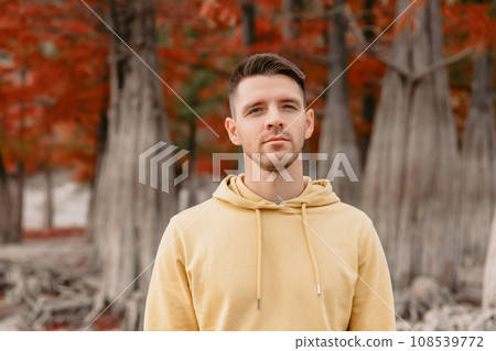 Cute child girl walking and playing in a autumnal forest. Little girl in warm clothes walks in the park Cute child girl walking and playing in a autumnal forest. Little girl in warm clothes walks in the park 108539772