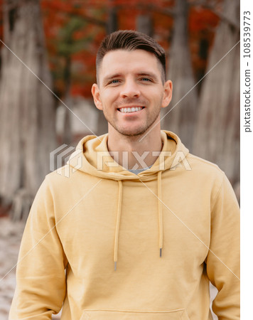 Cute child girl walking and playing in a autumnal forest. Little girl in warm clothes walks in the park 108539773