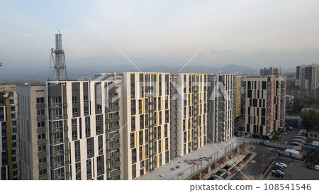Construction of tall houses near the road. Almaty Construction of tall houses near the road. Almaty 108541546