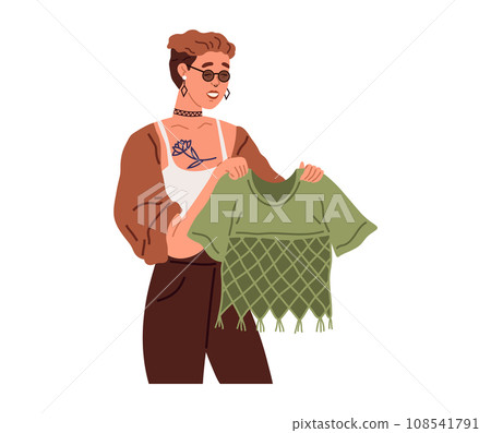 Woman chooses trendy t-shirt for party in womens clothing store. Person stands holds blouse in hands in dress market. Fashion designer, dressmaker, sewing specialist during work. Lady looks at outfit Woman chooses trendy t-shirt for party in womens clothing store. Person stands holds blouse in hands in dress market. Fashion designer, dressmaker, sewing specialist during work. Lady looks at outfit 108541791