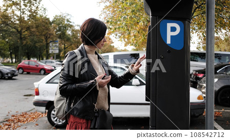 Woman Pays For Car Parking Via Parking Meter Using Credit Card 108542712