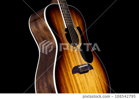 Mahogany Acoustic Guitar Isolated Upright on a Black Backgound Mahogany Acoustic Guitar Isolated Upright on a Black Backgound 108542795