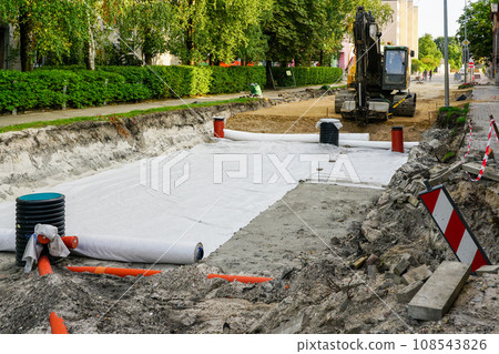 Use of geotextile fabric rolls for drainage and separation of base layers in street reconstruction Use of geotextile fabric rolls for drainage and separation of base layers in street reconstruction 108543826