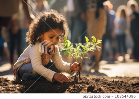 Beautiful little African American girl bending over tiny green sprout in the garden. Adorable child plants a plant in the ground. Fostering love of nature and concern for environment from childhood. Beautiful little African American girl bending over tiny green sprout in the garden. Adorable child plants a plant in the ground. Fostering love of nature and concern for environment from childhood. 108544396