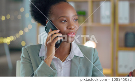 Phone call, communication and a business black woman in her office at night for networking or negotiation. Contact, planning or discussion with a young employee talking on her mobile in the workplace Phone call, communication and a business black woman in her office at night for networking or negotiation. Contact, planning or discussion with a young employee talking on her mobile in the workplace 108545083