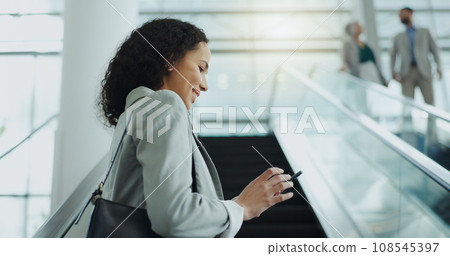 Business woman, phone text and airport with travel, smile and commute for work. Mobile, transport and online with a female person with journey and worker vacation with bag and happy on escalator Business woman, phone text and airport with travel, smile and commute for work. Mobile, transport and online with a female person with journey and worker vacation with bag and happy on escalator 108545397