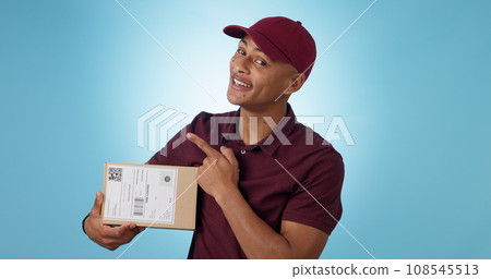 Portrait, happy man and courier for pointing in studio with mock up for announcement on blue background. Cape Town, male model and smile for presentation of alert, promotion or notification in space Portrait, happy man and courier for pointing in studio with mock up for announcement on blue background. Cape Town, male model and smile for presentation of alert, promotion or notification in space 108545513