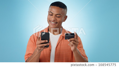 Man, credit card and phone in studio, smile on face, sale and discount with fintech by blue background. Person, smartphone and online shopping with e commerce, easy payment and happy with banking app 108545775