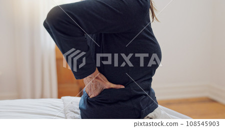 Senior woman, back pain and home bedroom with muscle problem and arthritis in retirement. Elderly patient, osteoporosis and injury on a bed with hands holding for support of inflammation with crisis Senior woman, back pain and home bedroom with muscle problem and arthritis in retirement. Elderly patient, osteoporosis and injury on a bed with hands holding for support of inflammation with crisis 108545903