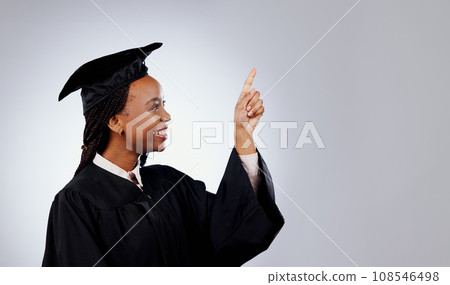 Graduate, woman pointing up and space for education, learning or college presentation and study opportunity in studio. African student information, registration steps or offer on a white background Graduate, woman pointing up and space for education, learning or college presentation and study opportunity in studio. African student information, registration steps or offer on a white background 108546498