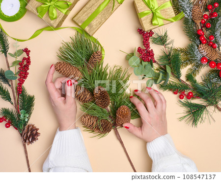 Woman is packing gifts, the pre-holiday bustle and preparations for Christmas Woman is packing gifts, the pre-holiday bustle and preparations for Christmas 108547137