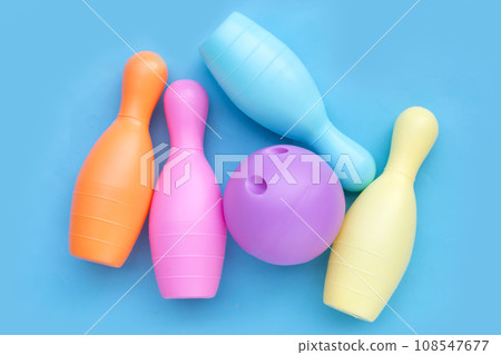 Colorful plastic bowling toy on blue background. 108547677