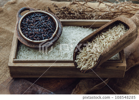Various types of rice : Brown rice, Jasmine rice, Riceberry on old wooden background. Organic raw rice collection, Healthy food and diet concept. Various types of rice : Brown rice, Jasmine rice, Riceberry on old wooden background. Organic raw rice collection, Healthy food and diet concept. 108548285