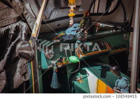 Dashboard and steering wheel and shift lever inside Thai traditional taxi or Three wheels vehicle  (3-wheeler taxi). Tuk-Tuk car interior design. 108548453