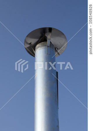 Metal chimney pipe on the roof of house Metal chimney pipe on the roof of house 108548926