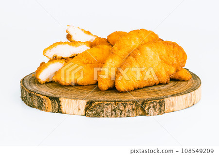 Chicken Breaded Fillet. Breaded chicken nuggets. Fast homemade food at home. Chicken breaded schnitzels. Breaded Chicken Inner Fillet on a White Background,Chicken Breaded Raw Meat. Fast cooking. 108549209