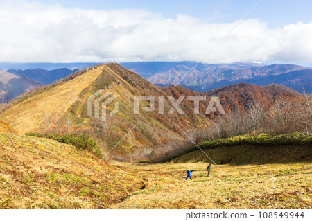 Parent and child walking on Mt. Tanigawa with autumn leaves 108549944