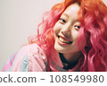 a woman with bright pink hair smiles for the camera 108549980