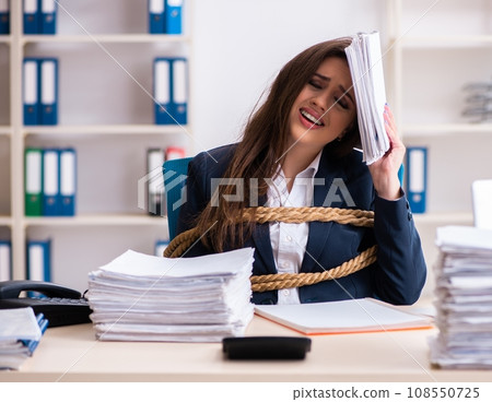 Young beautiful employee tied up with rope in the office Young beautiful employee tied up with rope in the office 108550725