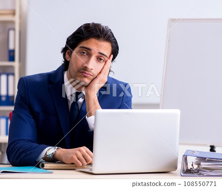 Young handsome businessman working in the office Young handsome businessman working in the office 108550771