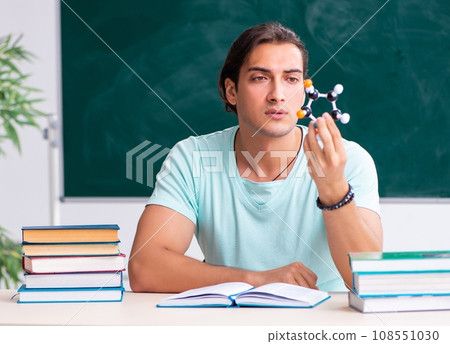 Young male student sitting in the classroom Young male student sitting in the classroom 108551030