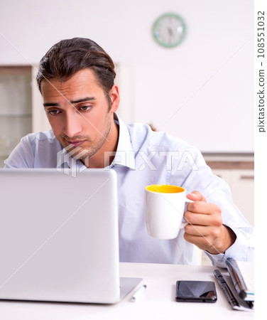 Young male businessman working at home 108551032