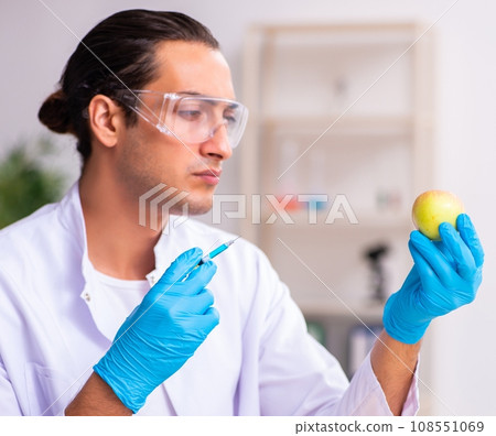 Young male nutrition expert testing food products in lab 108551069