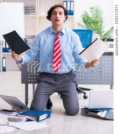 Young male employee unhappy with excessive work 108551072
