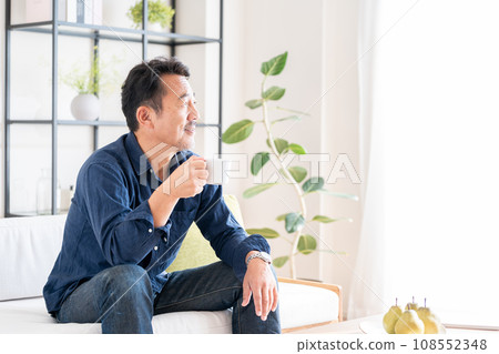 A senior man relaxing in the living room. A senior man relaxing in the living room. 108552348
