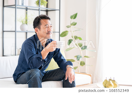 A senior man relaxing in the living room. A senior man relaxing in the living room. 108552349