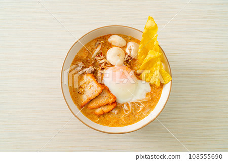 Rice vermicelli noodles with meatball, roasted pork and egg in spicy soup Rice vermicelli noodles with meatball, roasted pork and egg in spicy soup 108555690