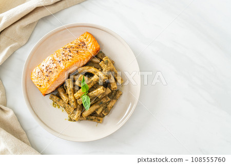 pesto quadrotto penne pasta with grilled salmon 108555760