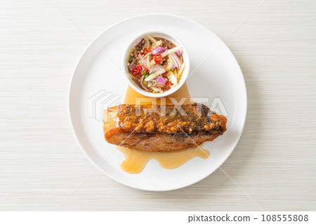 fried snapper fish with fish sauce and spicy salad 108555808