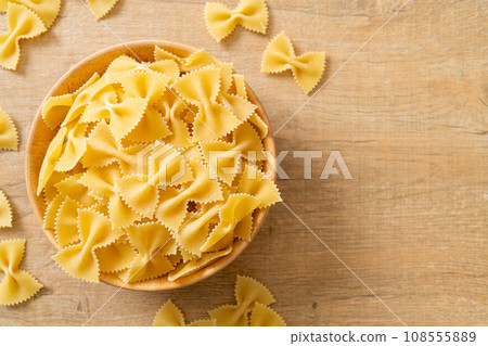 Dry uncooked farfalle pasta in bowl Dry uncooked farfalle pasta in bowl 108555889