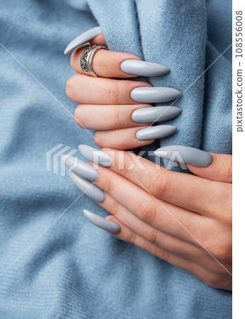Blue manicure nails with a blue scarf Blue manicure nails with a blue scarf 108556008