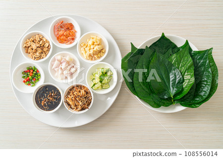 Miang kham - A royal leaf wrap appetizer Miang kham - A royal leaf wrap appetizer 108556014