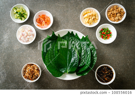 Miang kham - A royal leaf wrap appetizer Miang kham - A royal leaf wrap appetizer 108556016