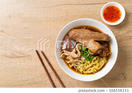 egg noodles with stewed and braised duck in brown soup 108556151