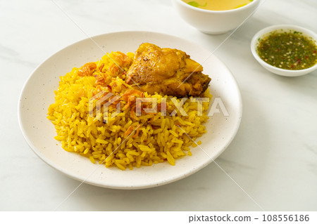 Chicken Biryani or Curried rice and chicken - Thai-Muslim version of Indian biryani, with fragrant yellow rice and chicken 108556186